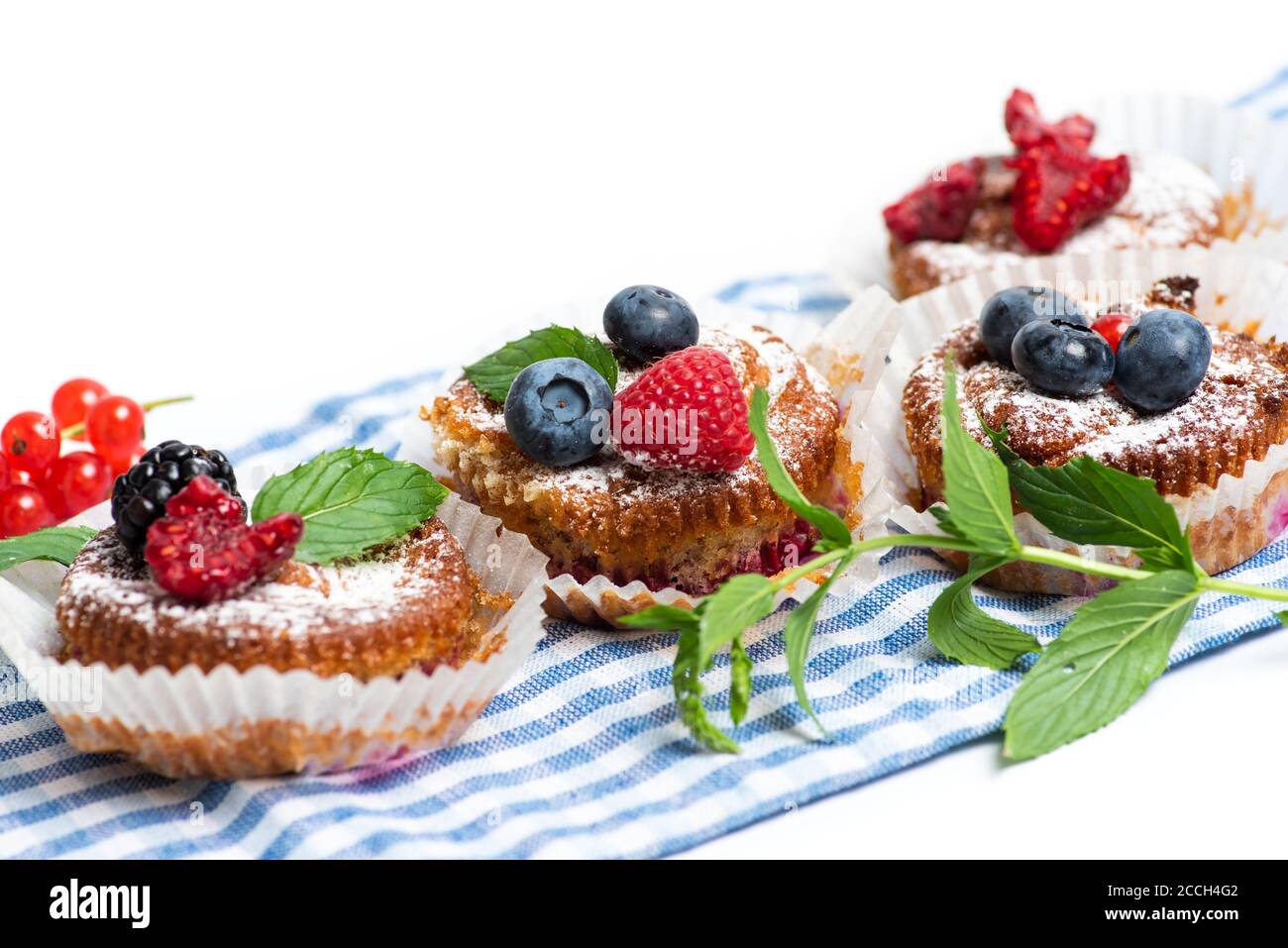 Mixed berry fruit muffins with raspberry blackberry and blueberry isolated Stock Photo