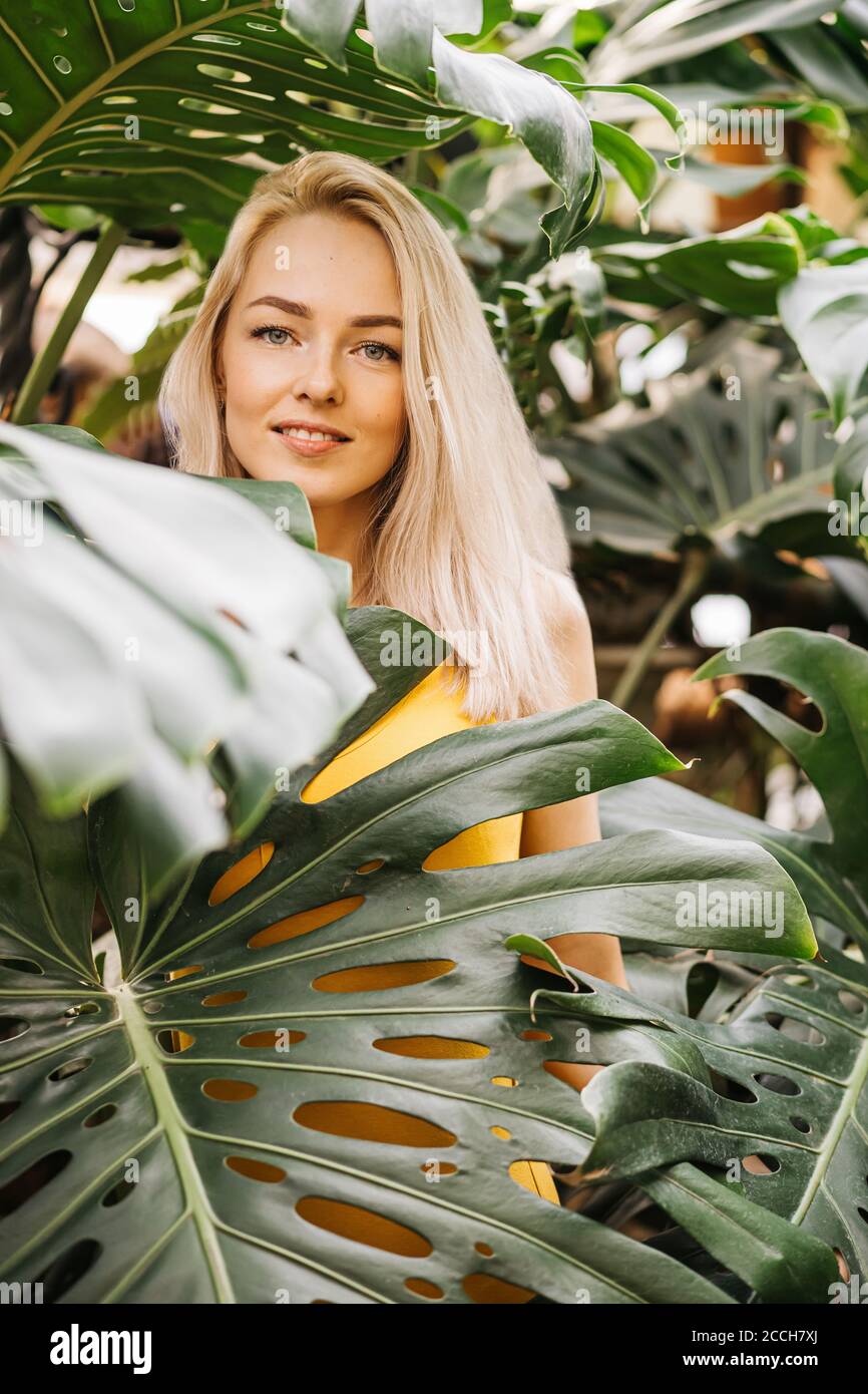 Portrait of gorgeous lady in stylish swimsuit posing in rainforest, enjoying summer, spending time in nature. Natural beauty concept. Blonde girl gent Stock Photo
