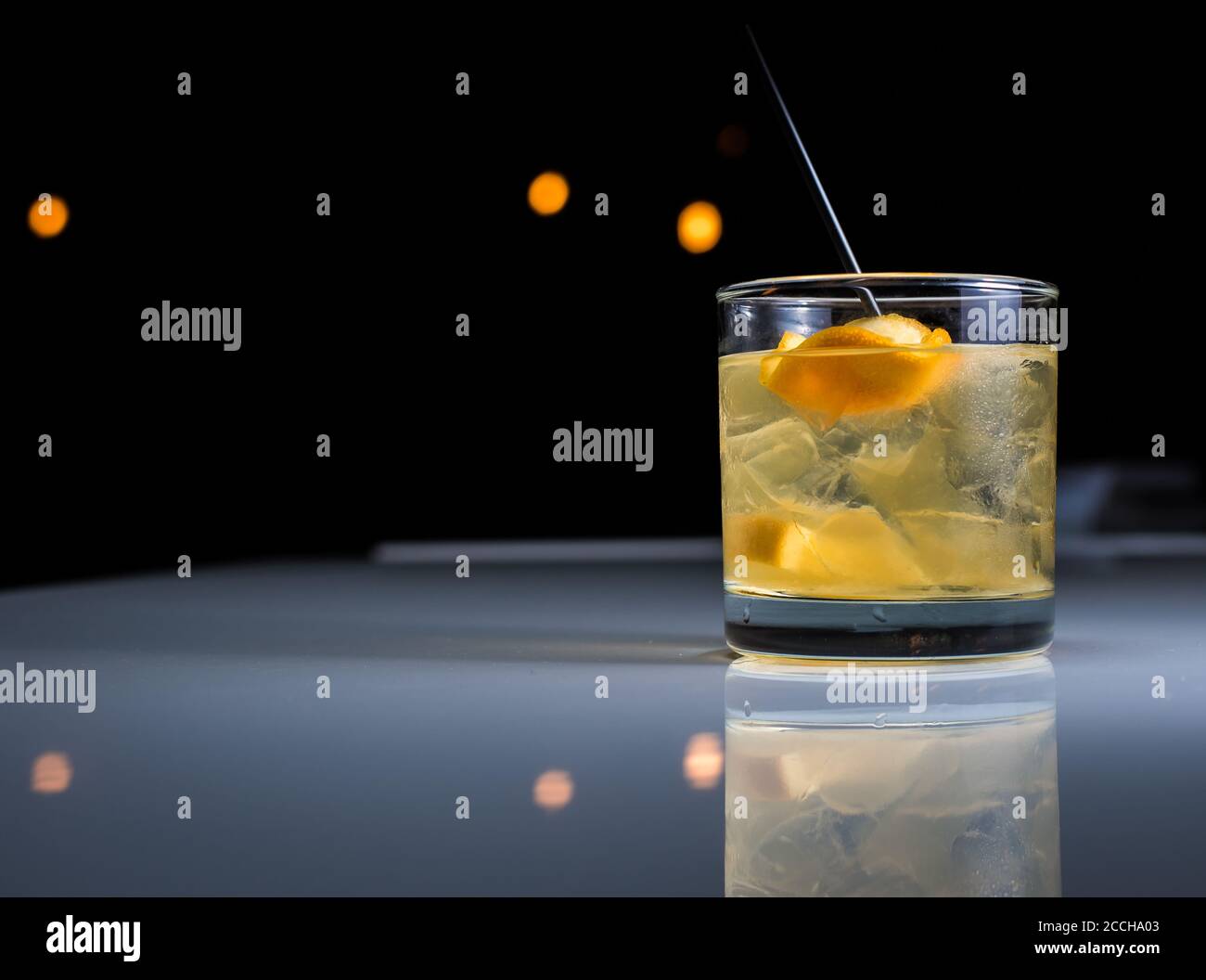 A modern craft cocktail served on the rocks in a glass with orange peel