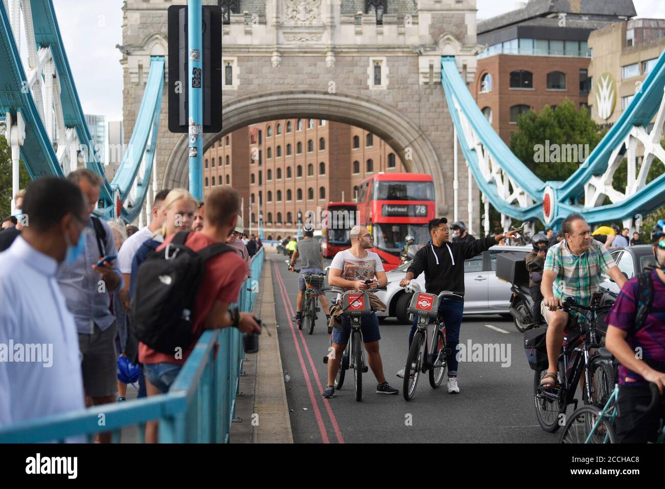 Traffic and pedestrians waiting on the approach to Tower Bridge in London, after the bridge became stuck open, causing traffic chaos. Stock Photo