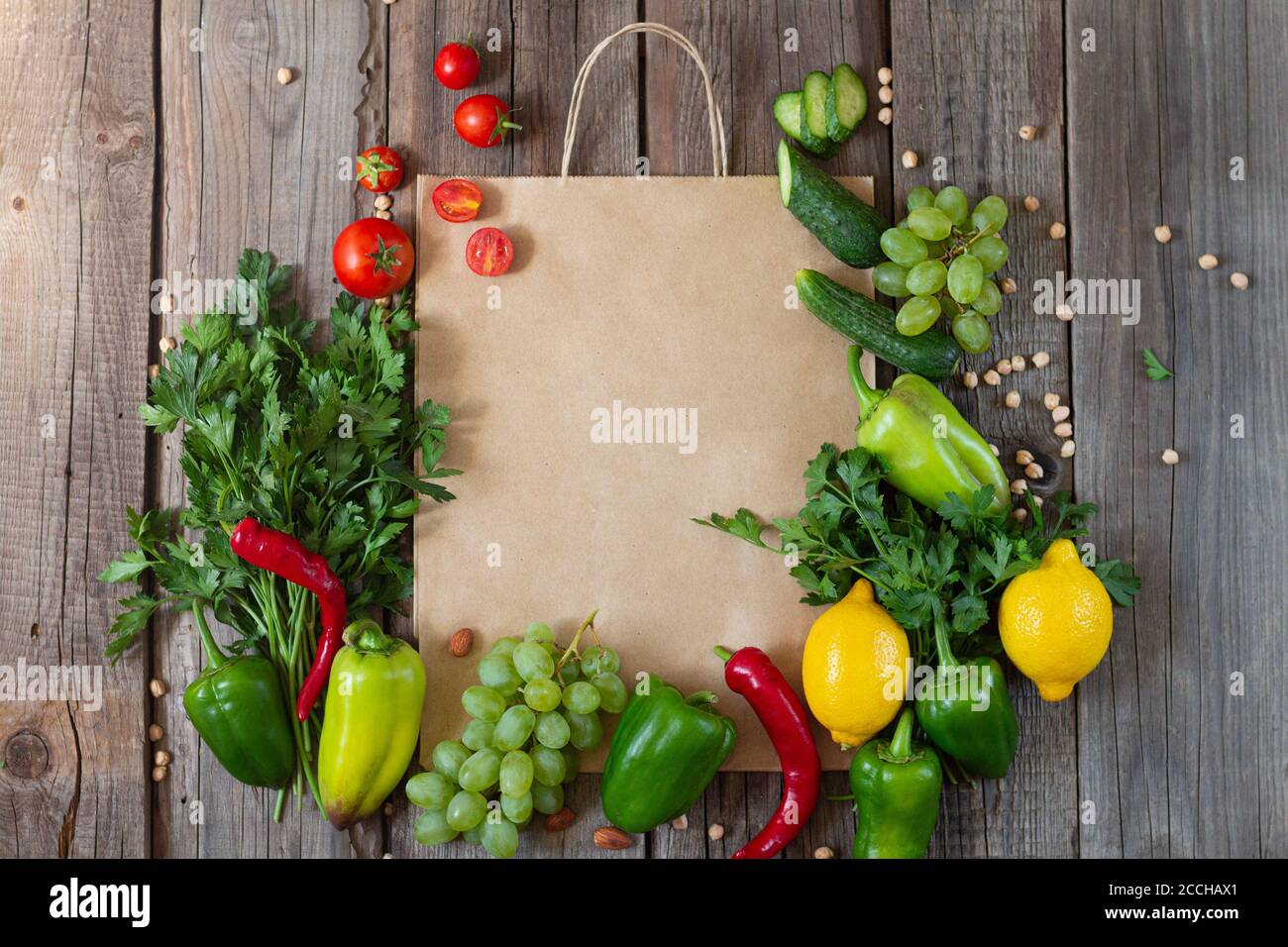 Paper grocery bag with fresh vegetables and fruits on rustic wooden ...
