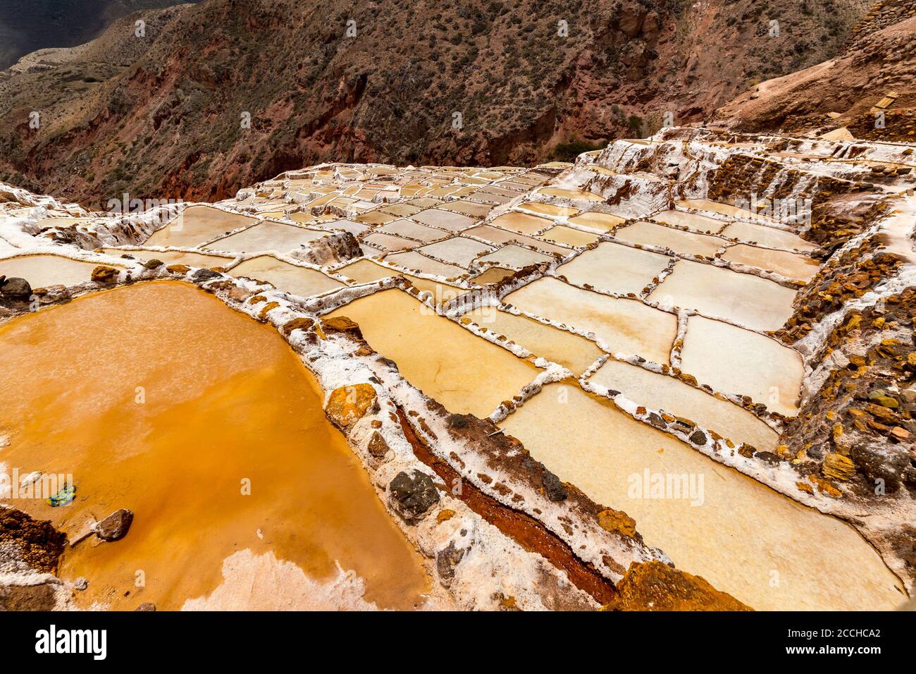 Salt ponds in Maras, Peru. Since pre-Inca times, salt has been obtained in Maras by evaporating salty water from a local subterranean stream. Stock Photo