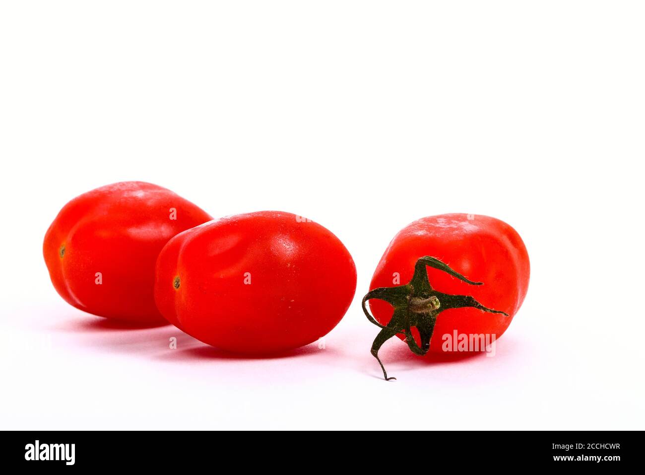 Baby plum tomatoes isolated on a white background Stock Photo - Alamy