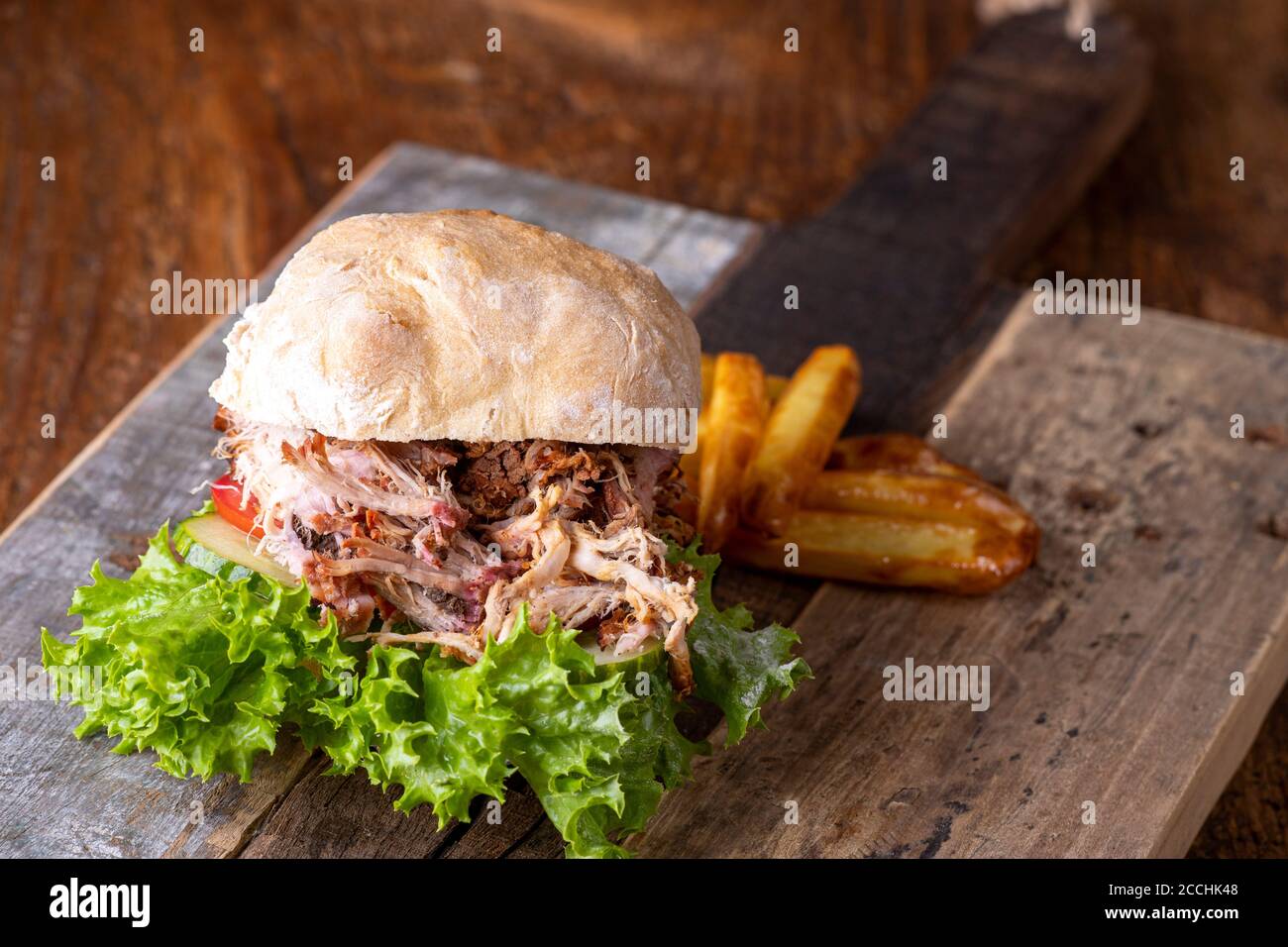 pulled pork in a bun with fries Stock Photo