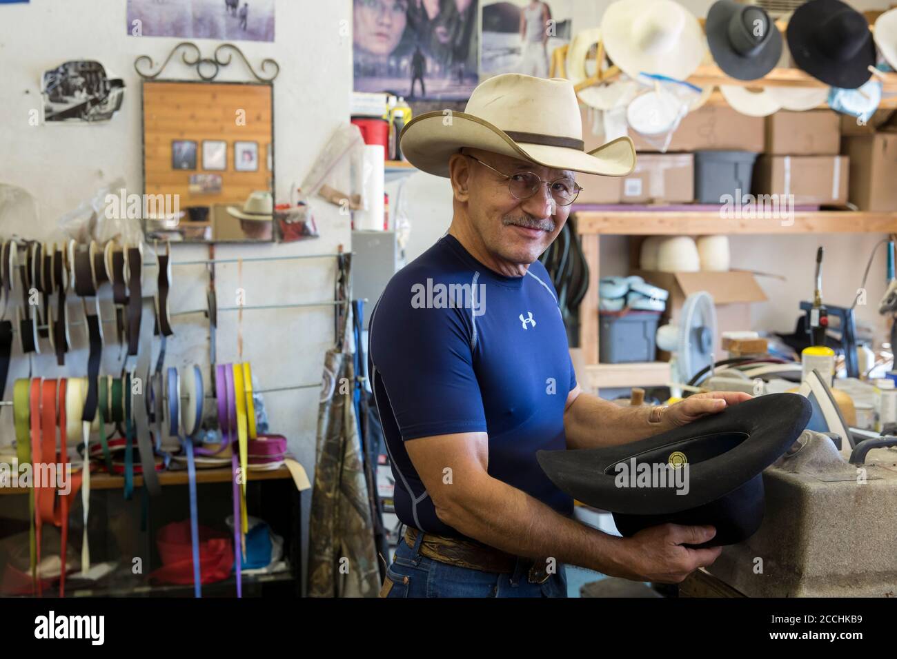 Jimmy 'The Hat Man' Harrison shapes a hat in his workshop in the Double H Custom Hat Company in Darby, Montana on July, 31, 2020. Stock Photo