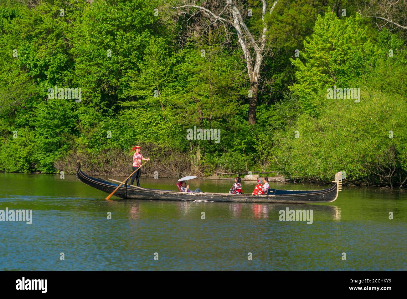 People enjoy riding on Gondola on The Lake in Central Park Stock Photo