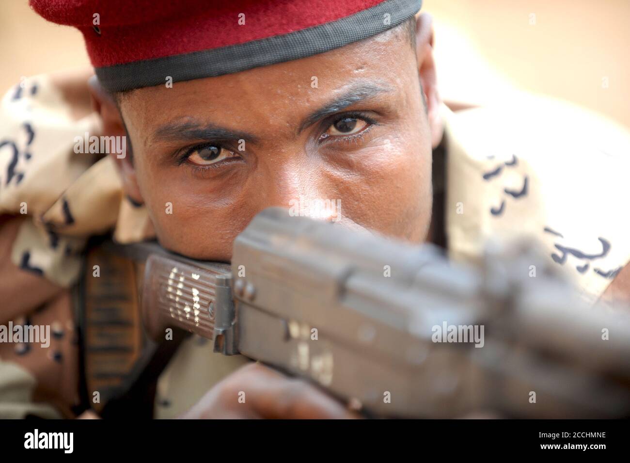 Djibouti Army Squad Leader Sgt. Abeh Abdullah aims his weapon during a contact drills practical application February 2, 2011 in Ali Oune, Djibouti. Djiboutian Army soldiers are partnering with U.S. Army National Guard soldiers for an infantry skills training event. Stock Photo