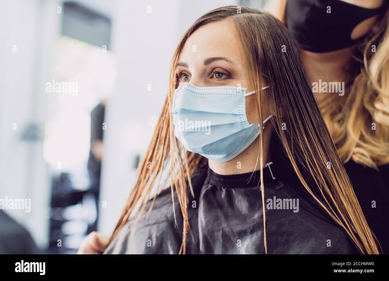Hairdresser and customer during covid-19 pandemic Stock Photo
