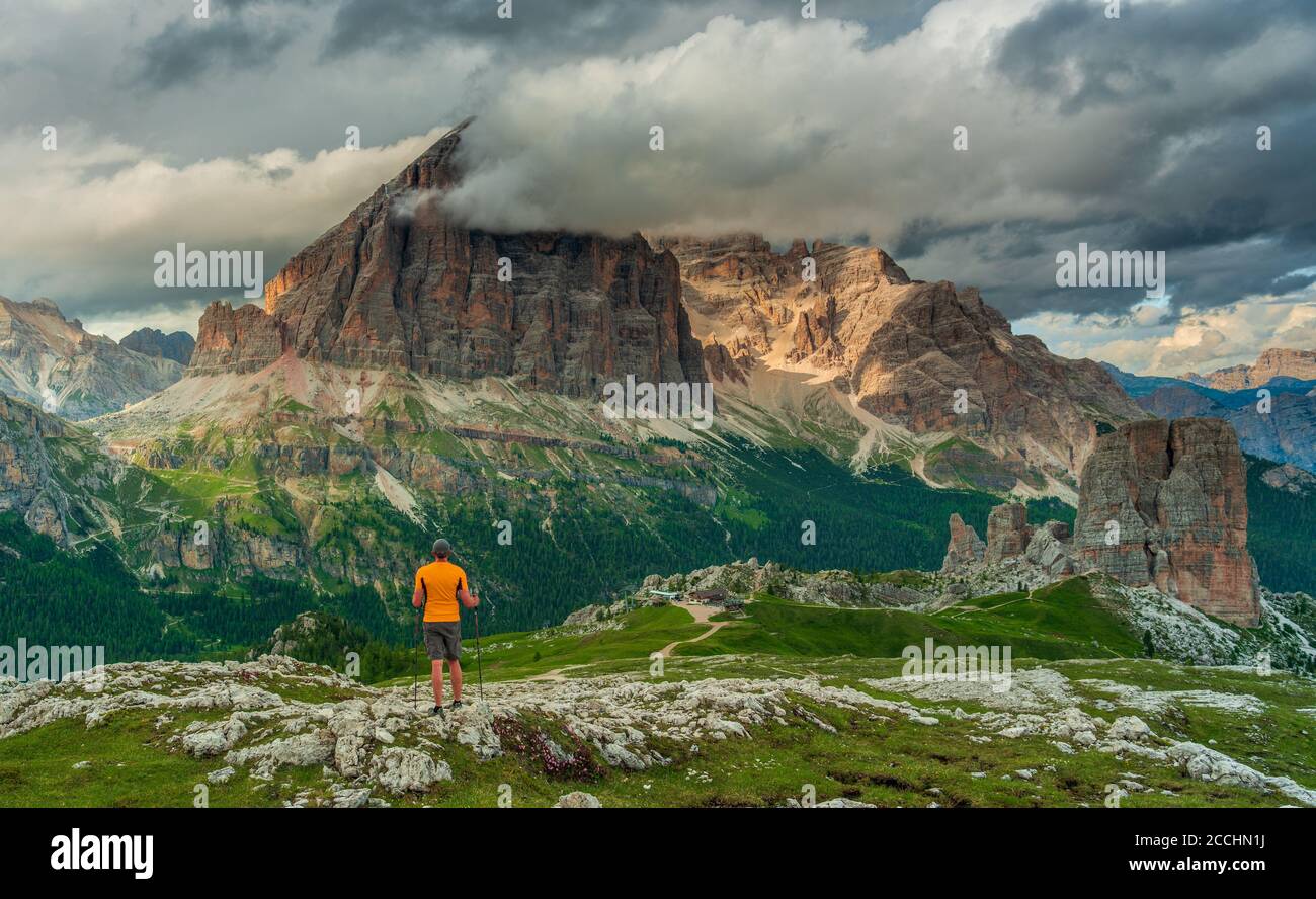 person looking at clouds covered mountains in Italian Dolomites Stock ...