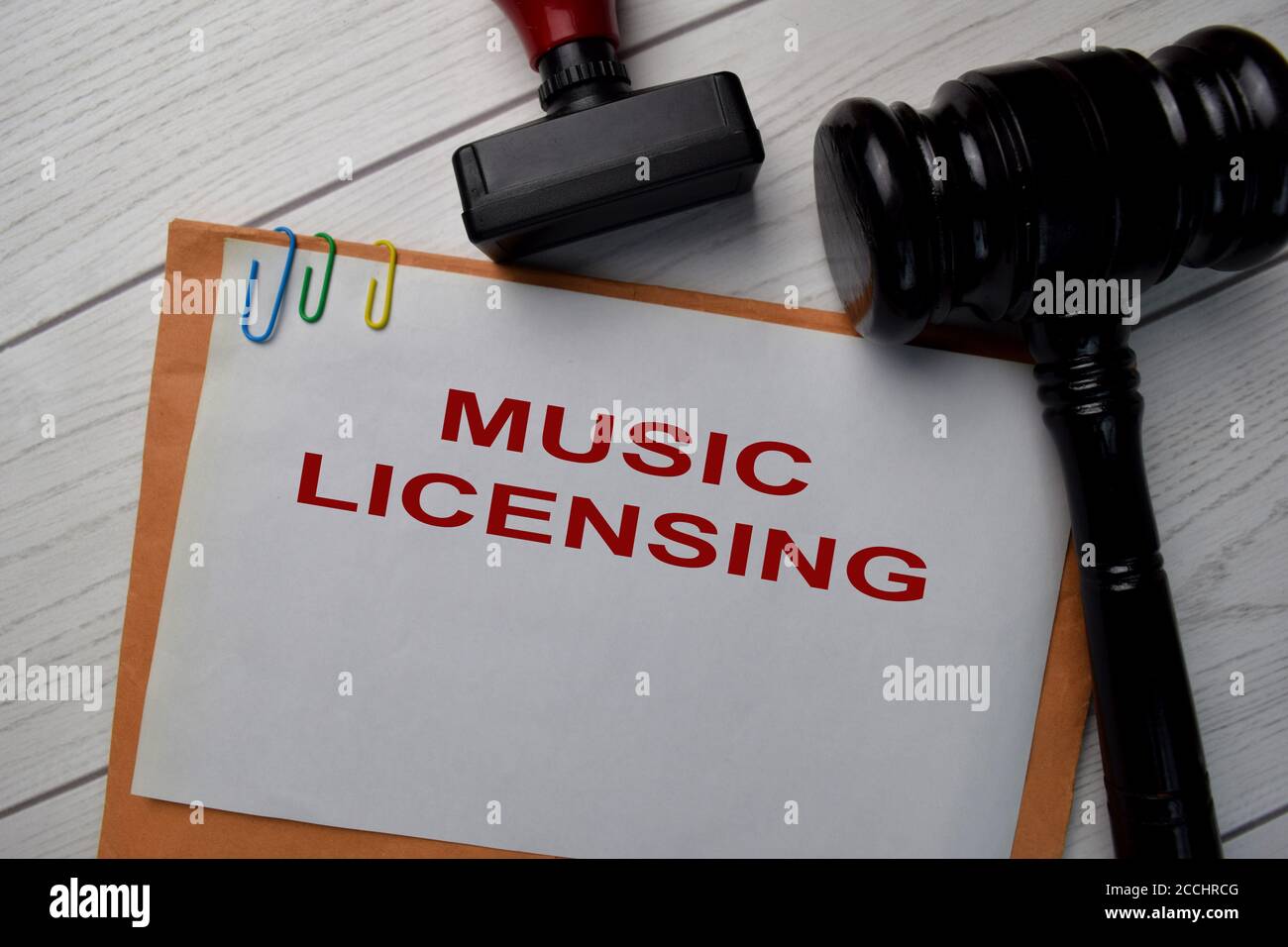 Music Licensing text with document brown envelope and stethoscope isolated on office desk. Stock Photo