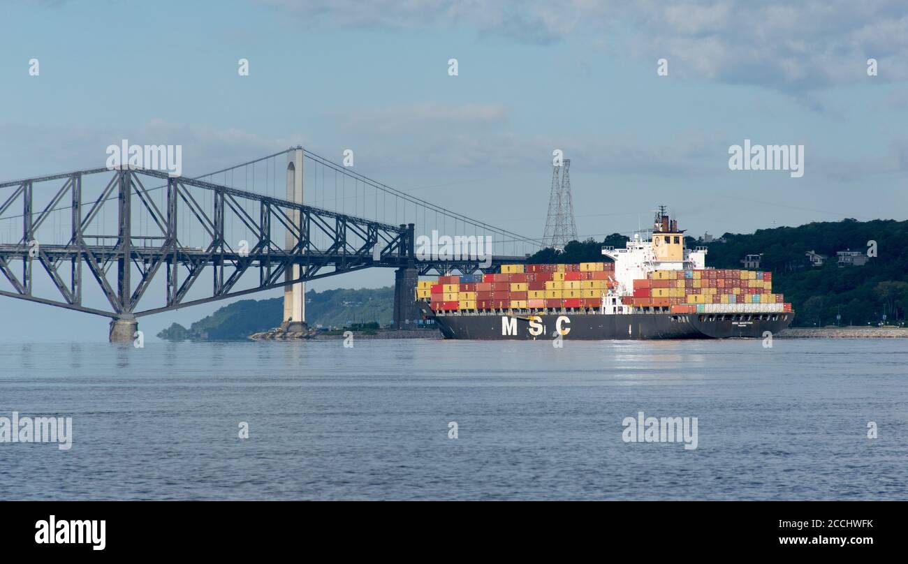 Cargo ship on the St-Lawrence river sailing under the Quebec bridge Stock Photo