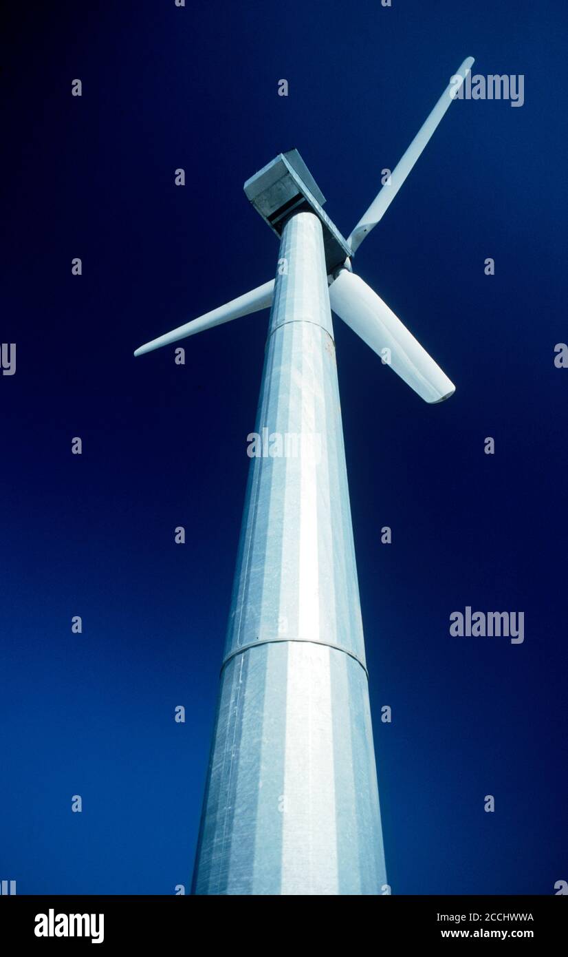 Single tall wind turbine under blue desert sky near Palm Springs, California Stock Photo