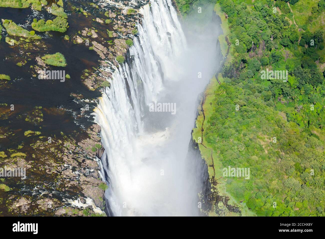 Aerial view of Victoria Falls located Zimbabwe and Zambia border. Zambezi River waterfall in Africa. Helicopter view of the fall. Stock Photo
