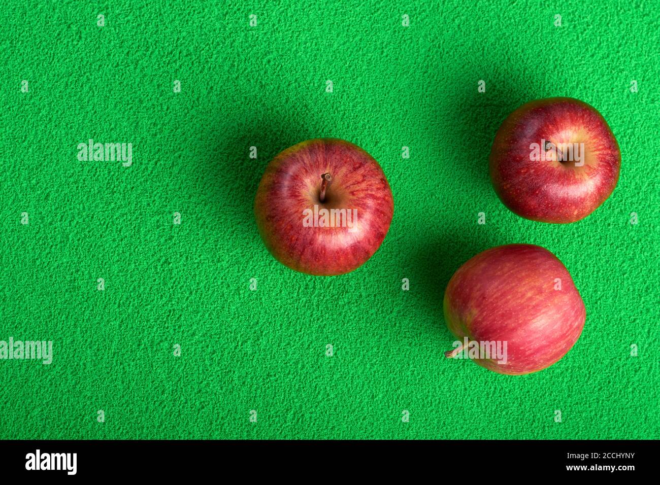 ripe red apples on a green background.selective focus Stock Photo