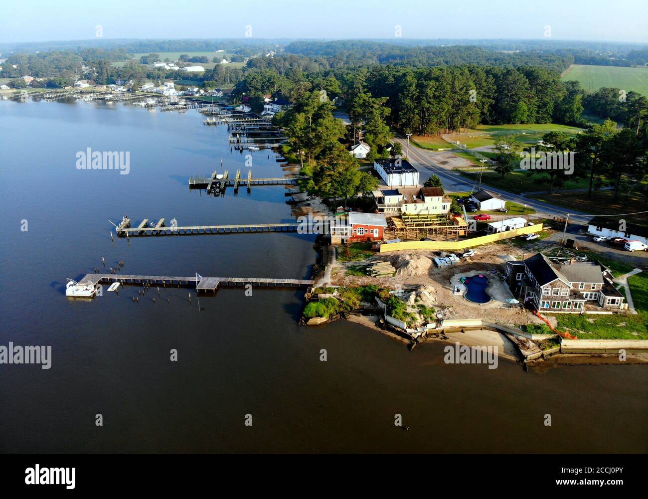 The aerial view of the waterfront homes with a private dock near