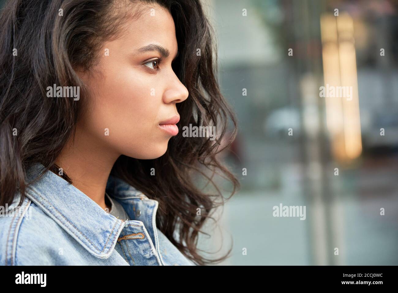 Confident young African American woman looking forward on urban street. Stock Photo