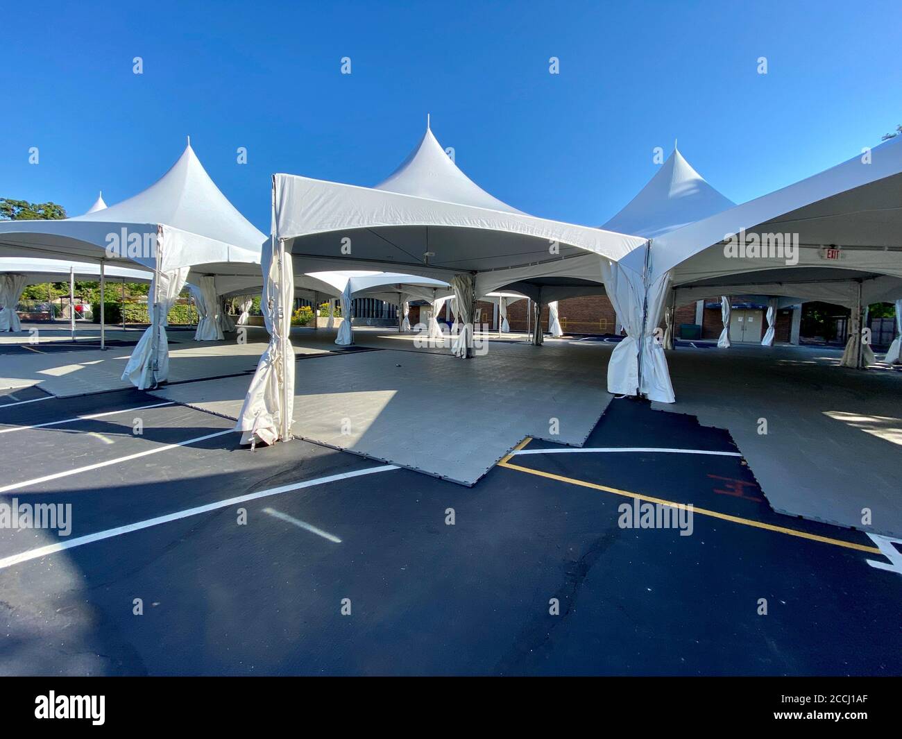 Schools prepare for in-person learning by constructing tents on the blacktop for outdoor classrooms during the Coronavirus pandemic. Stock Photo