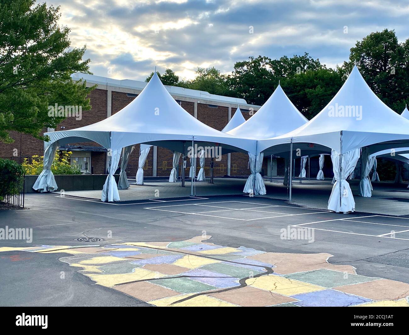 Schools prepare for in-person learning by constructing tents on the blacktop for outdoor classrooms during the Coronavirus pandemic. Stock Photo