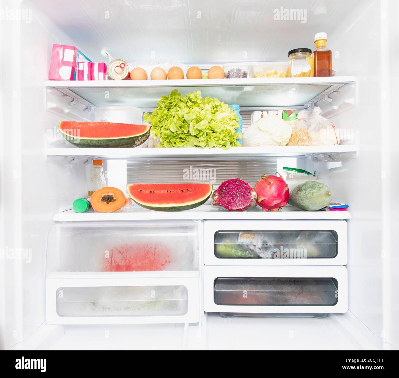 Open refrigerator full of products inside Stock Photo