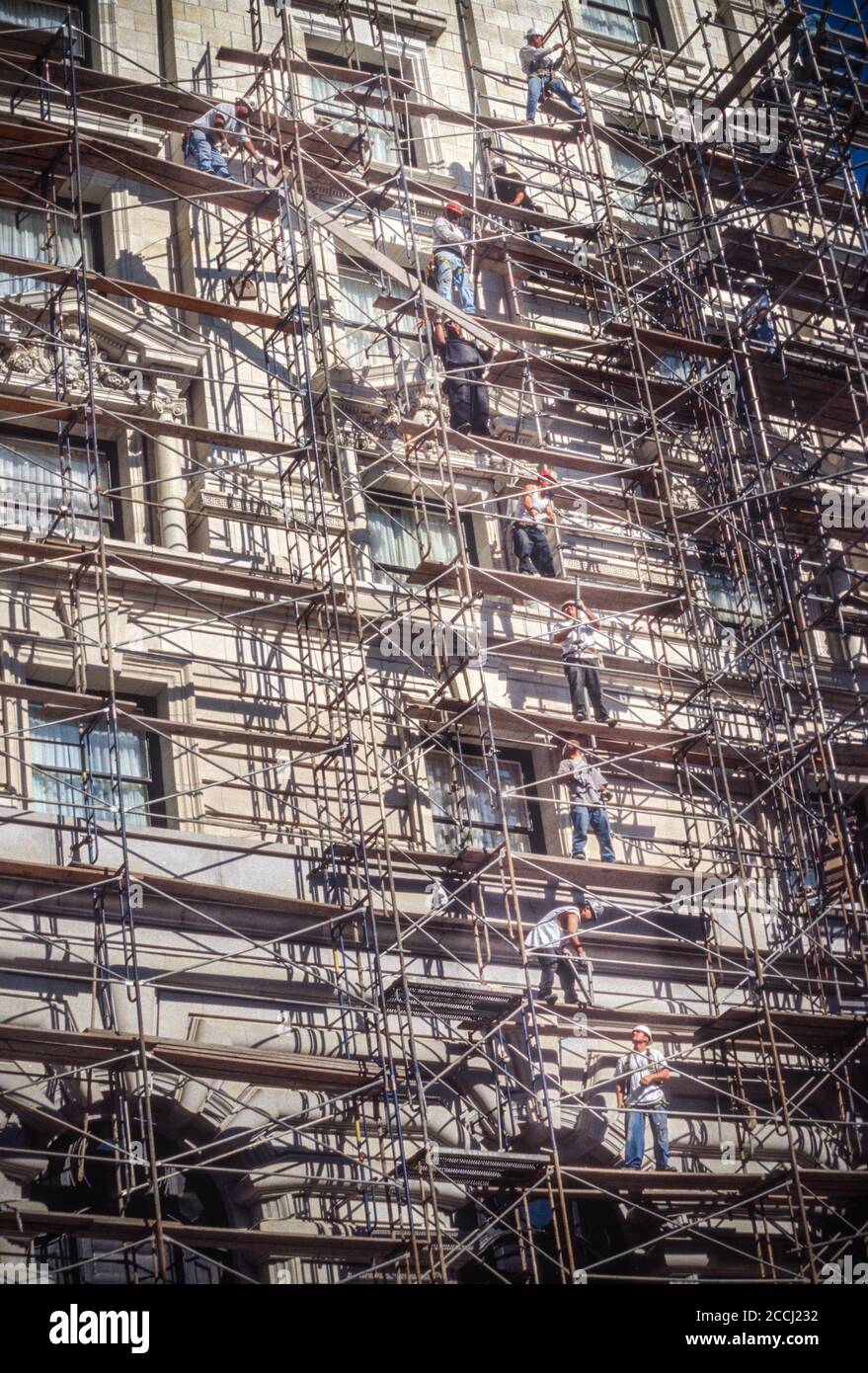 San Francisco, California, USA. Teamwork: Disassembling a Scaffold. Stock Photo