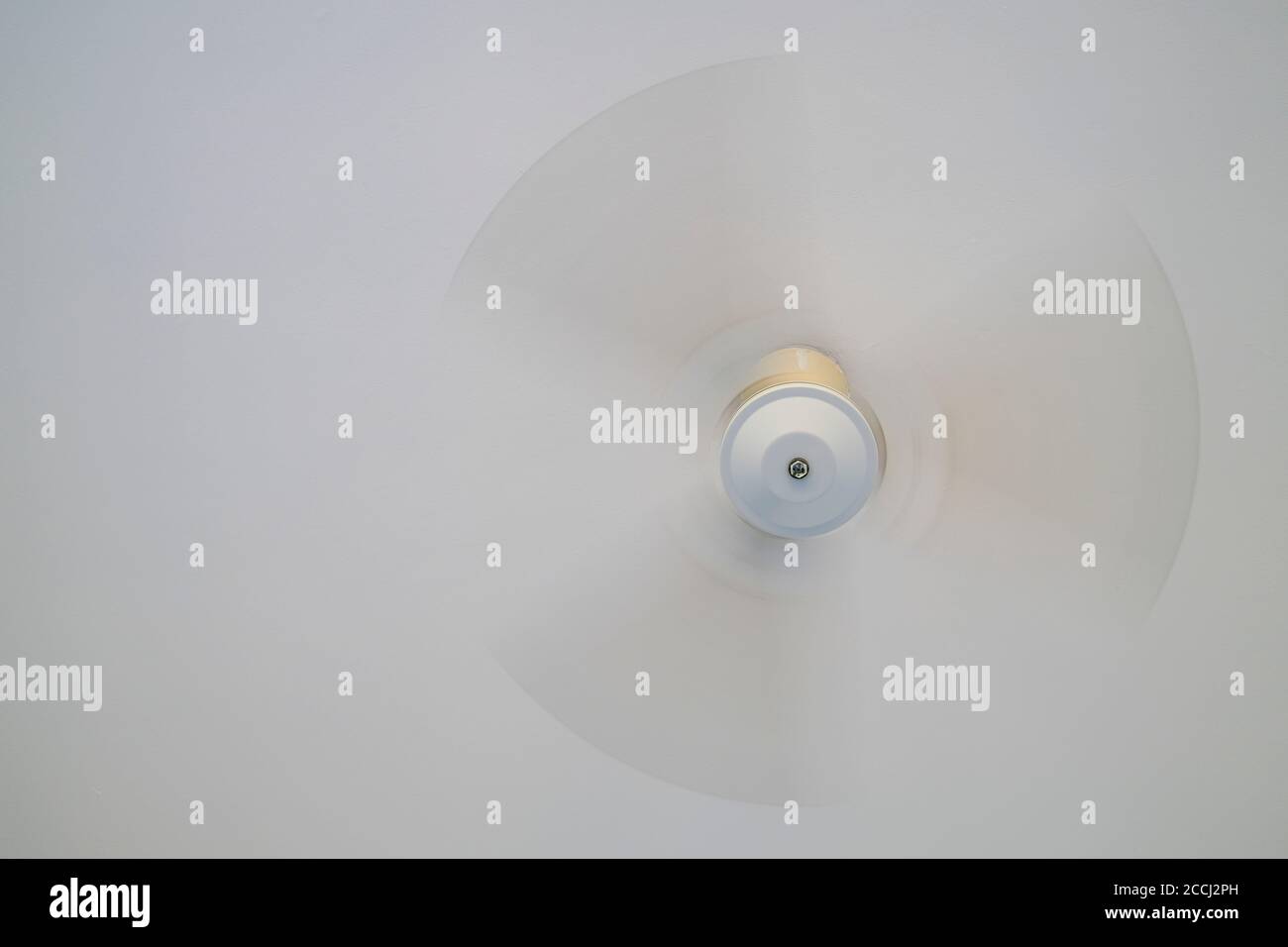 Ceiling fan turning under a white ceiling Stock Photo