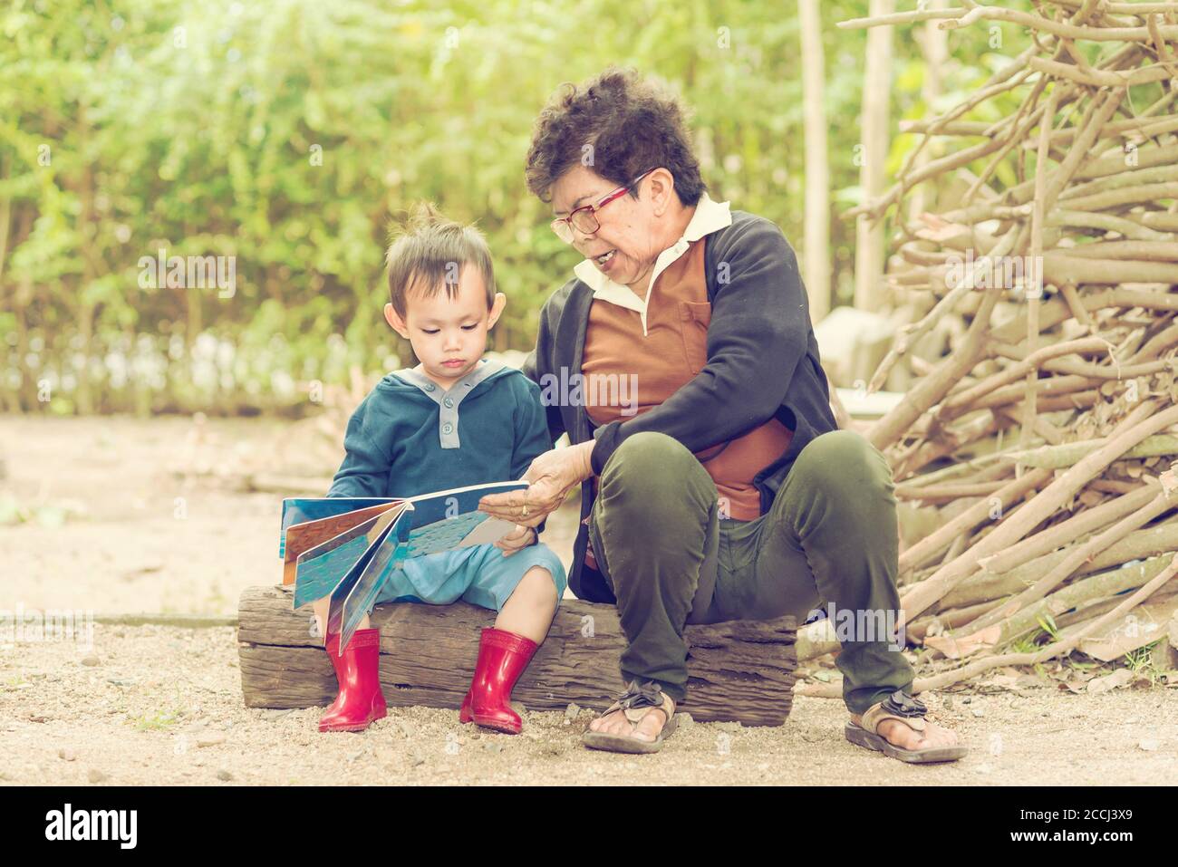 Grand mother teach kid to read Stock Photo