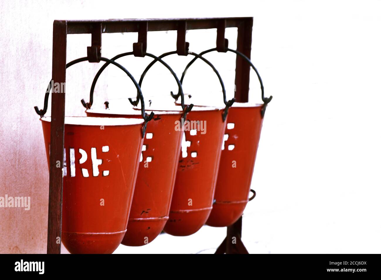 Fire Safety Sand Bucket hanging against white background Stock Photo