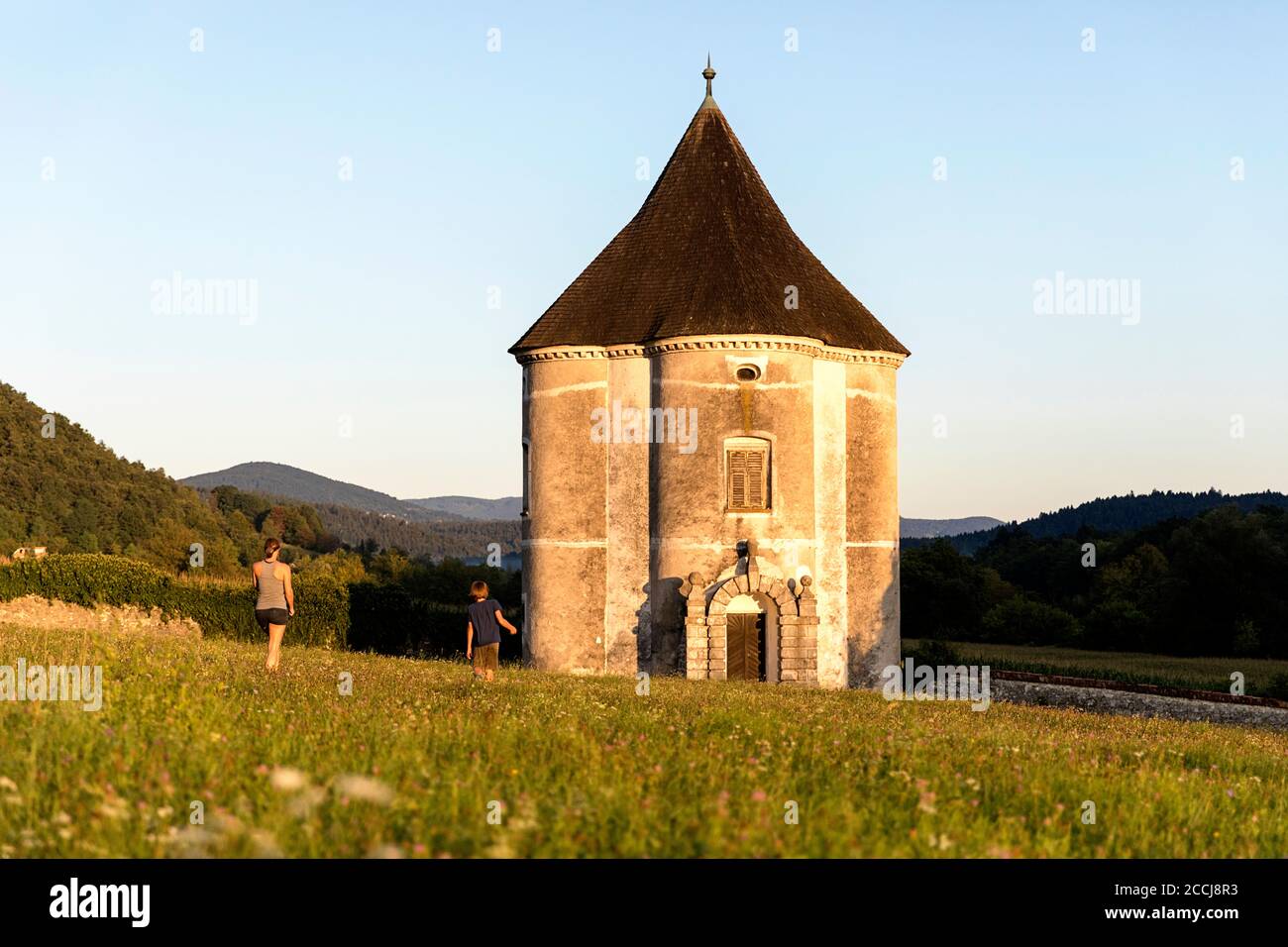 Mother and son walking to the Devil's tower in Soteska at sunset, Slovenia Stock Photo
