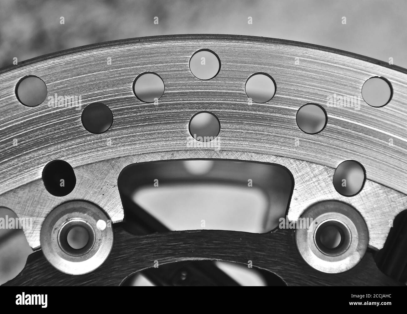 A macro image of stainless steel cogs and and plates as found in a disc brake system on a high end classic motorbike. Stock Photo