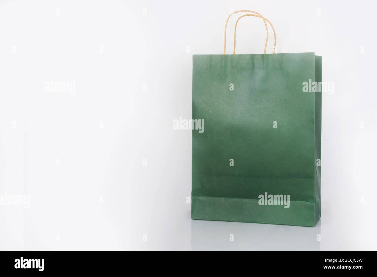 Plain green paper bag packaging on a white background with copy space Stock Photo
