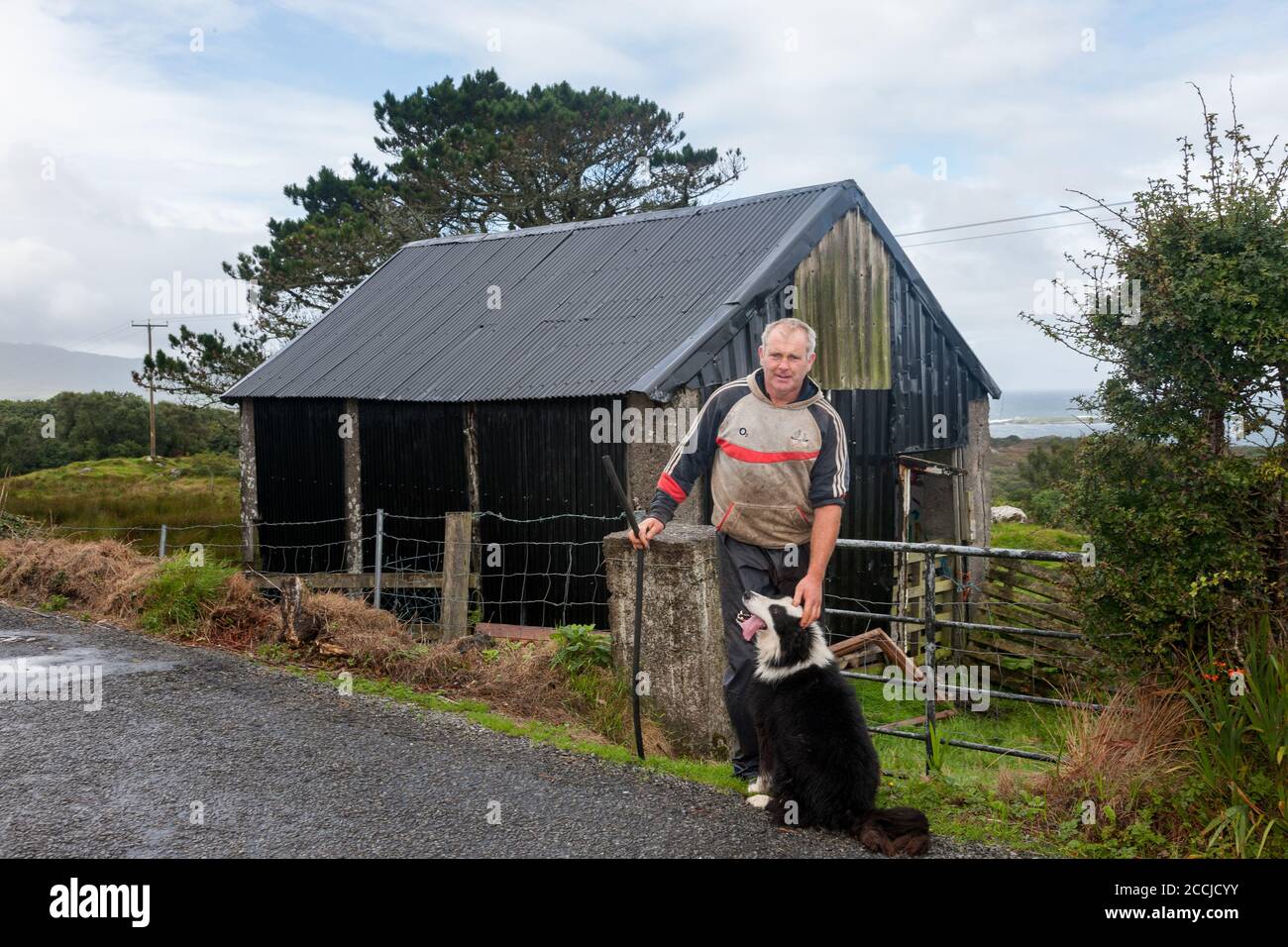 Eyeries, Cork, Ireland. 22nd August, 2020. Seán O'Shea with his sheepdog Max at his farm near Eyeries in West Cork, Ireland.  - Credit; David Creedon / Alamy Live News Stock Photo