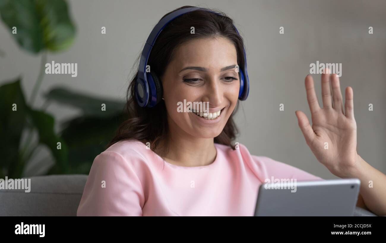Smiling arabic woman in headphones talk using pad Stock Photo - Alamy