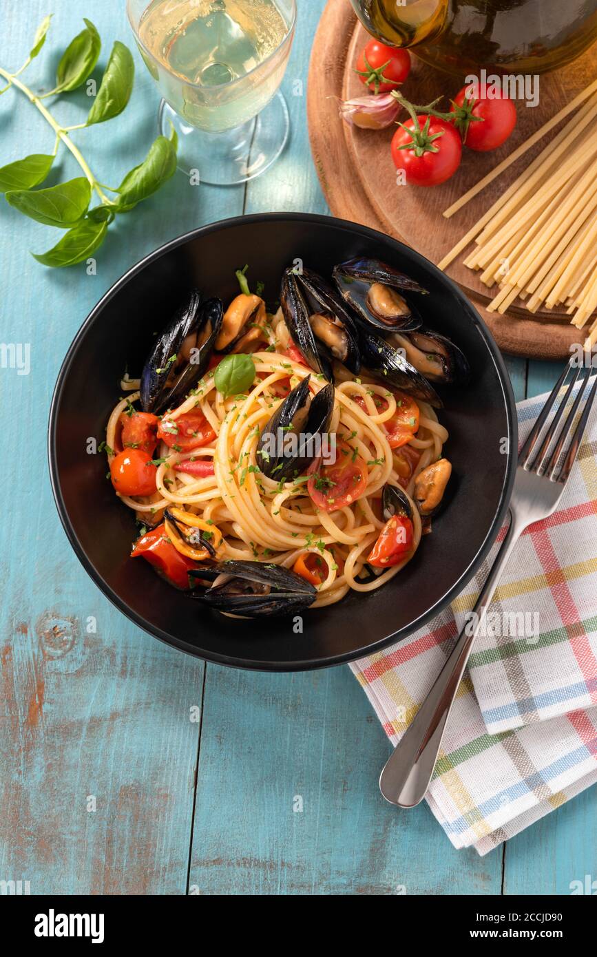 Plate of delicious spaghetti with cherry tomatoes and mussel sauce, a