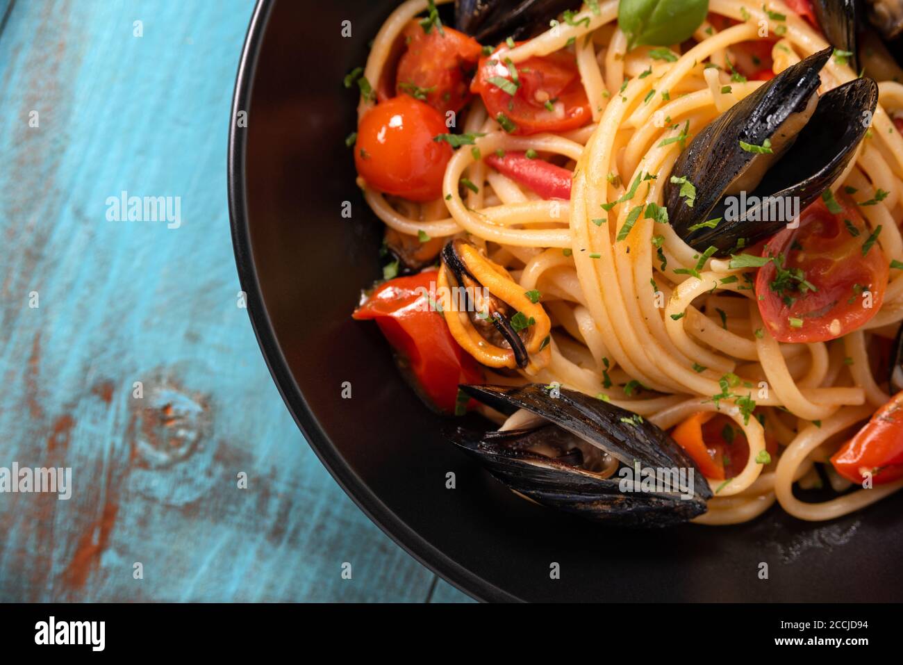 Plate of delicious spaghetti with cherry tomatoes and mussel sauce, a typical Italian Food Stock