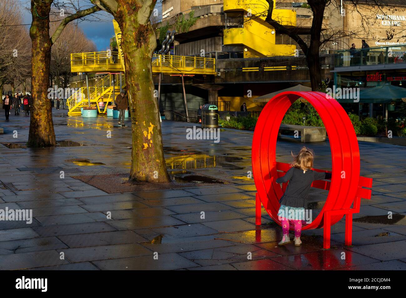 Southbank London Thames Path sunset view and little girl playing at one of the Jeppe Hein's Modified Social Benches in the South Bank London UK Europe Stock Photo