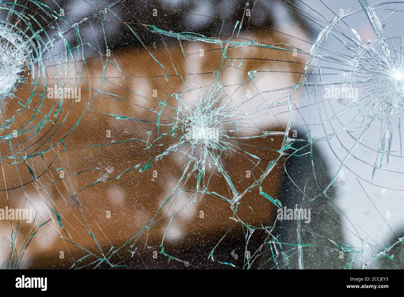 broken glass. Car glass cracked from an accident. Armored glass after impact. glass reinforced with a film after being hit by a bullet. Stock Photo