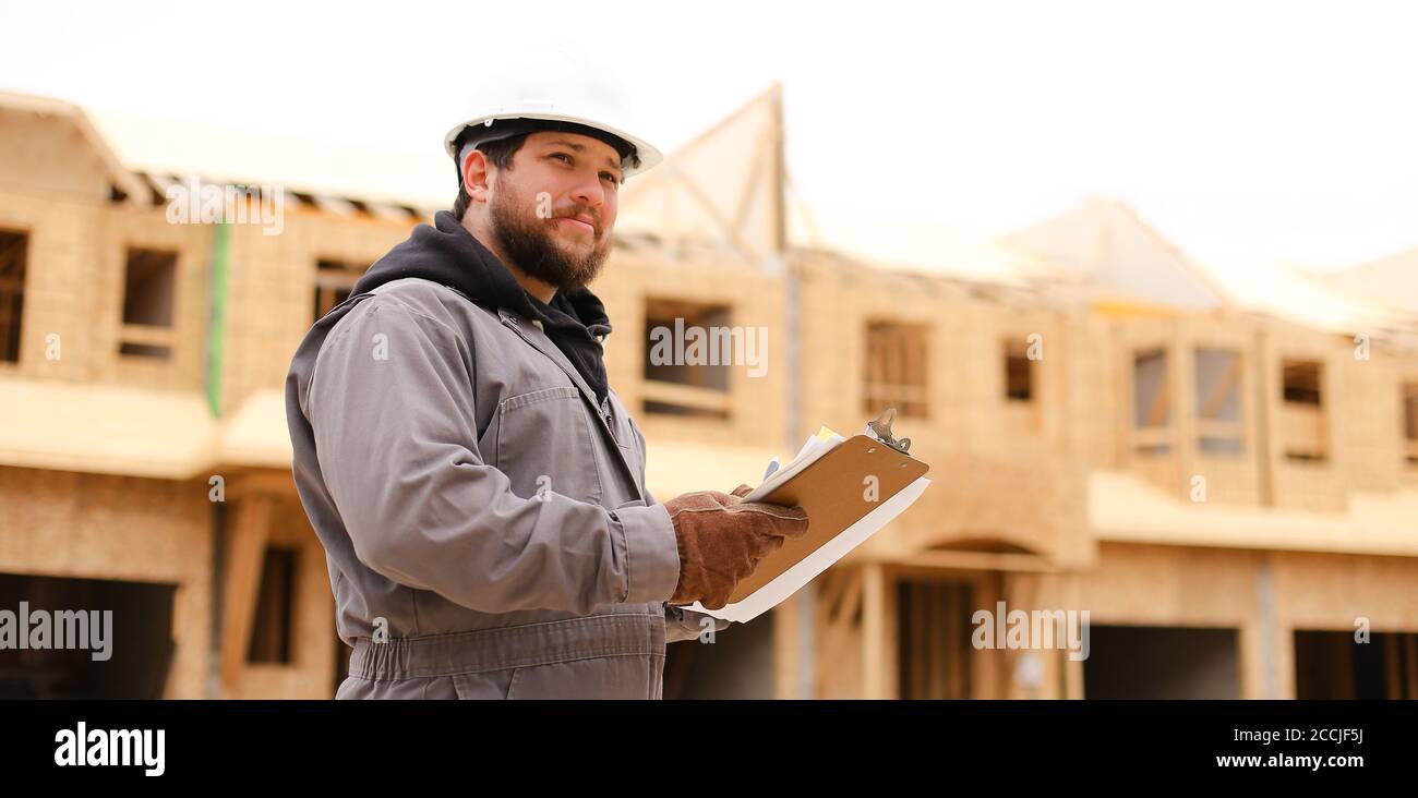 Banner of architect drawing plan in notebook at construction site. Stock Photo