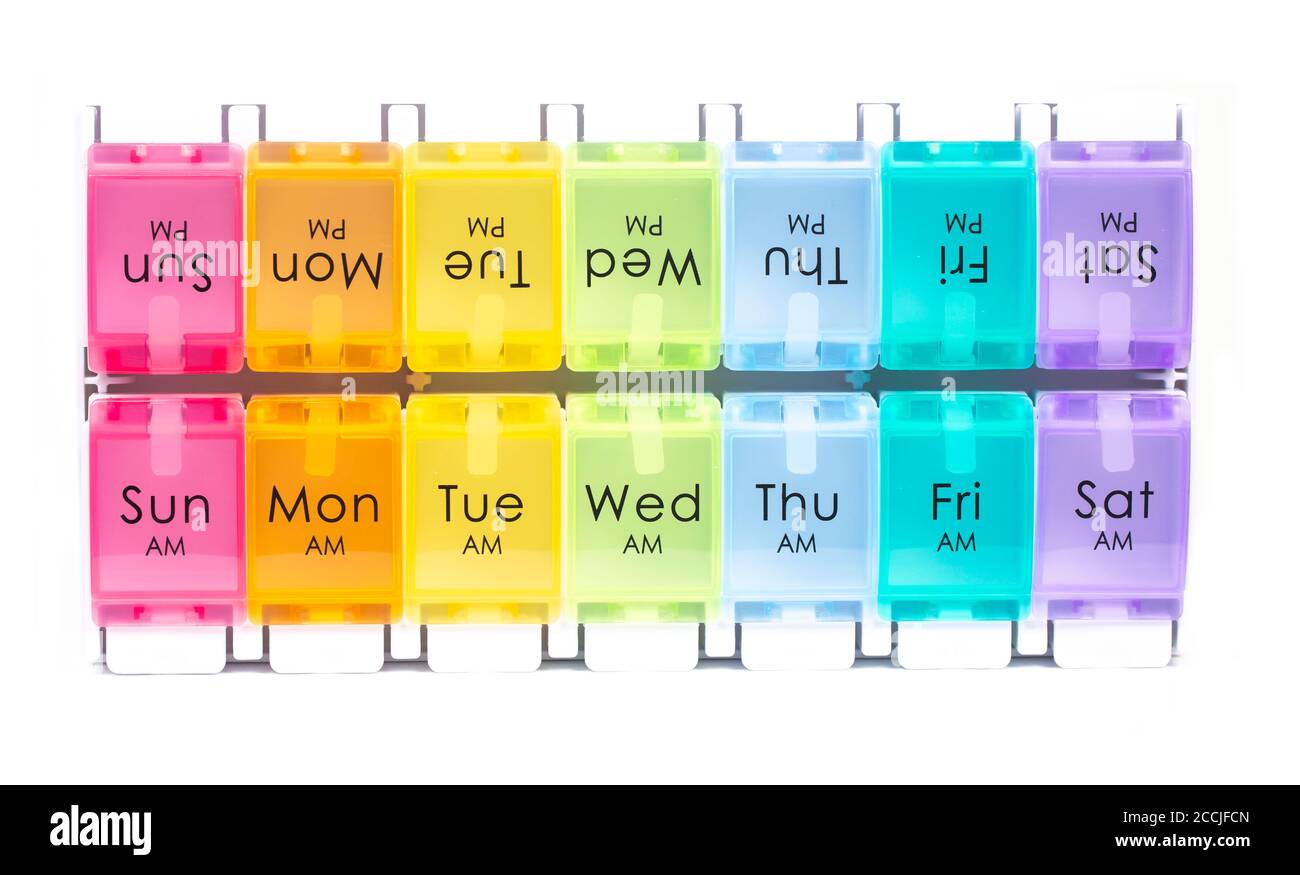 Colourful daily pill dispenser box on a white background Stock Photo