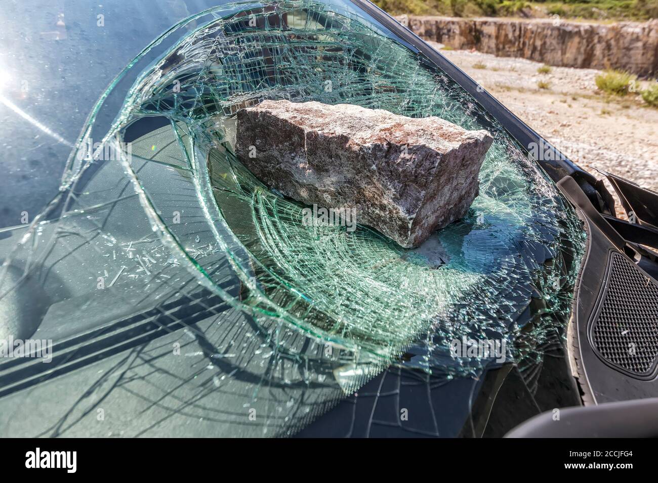 broken car windshield with a huge stone Stock Photo