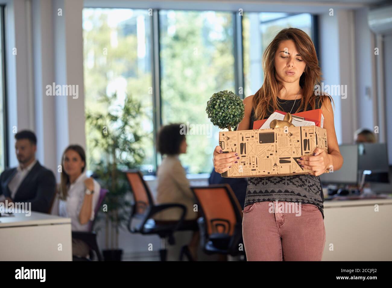 Young woman being sad because she got fired from the office Stock Photo