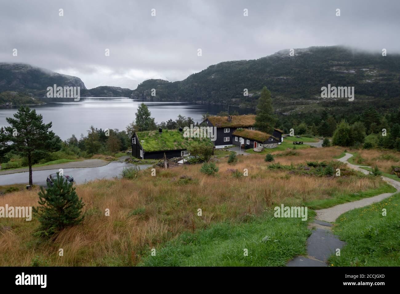 Traditional norwegian wooden houses with grass on the roof. Typical Norway architecture Stock Photo
