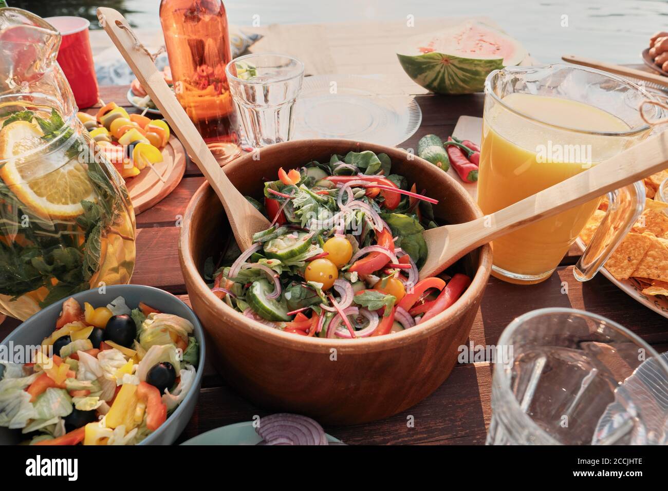 Close-up of bowl with fresh vegetable salad on the table for the dinner on fresh air Stock Photo