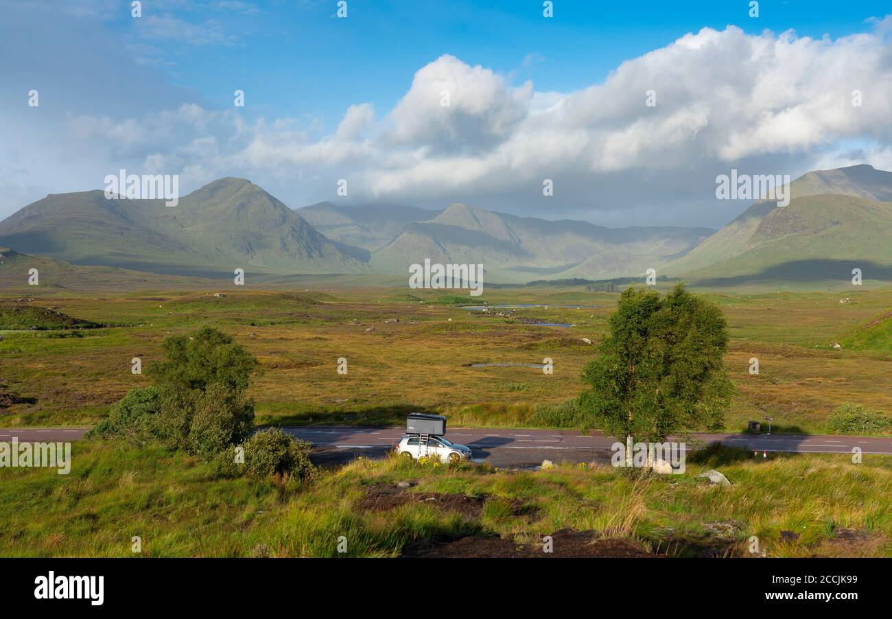 View  of Rannoch Moor in summer with car with roof tent on A82, Scotland, UK Stock Photo