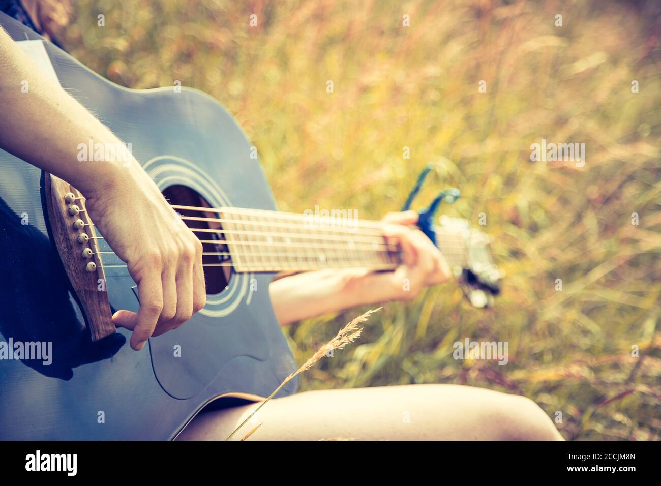 Close up of western guitar played outdoors at a river, summertime Stock  Photo - Alamy