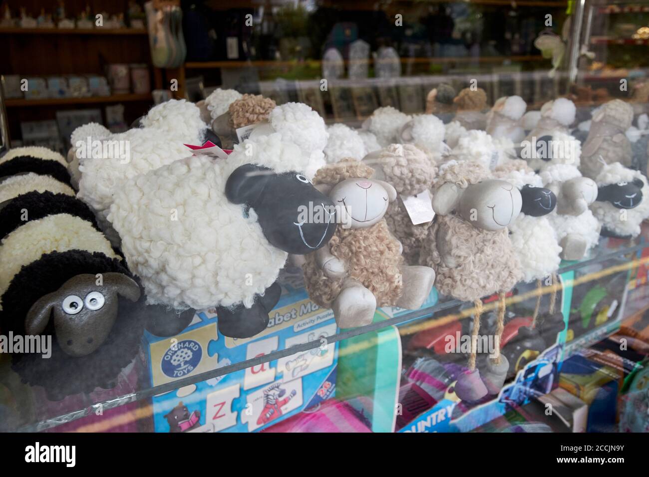sheep soft toys for sale in the window of a shop in coniston lake