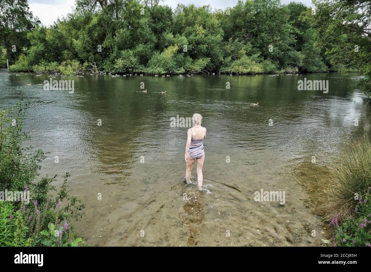 A woman about to swim in the river Thames Stock Photo