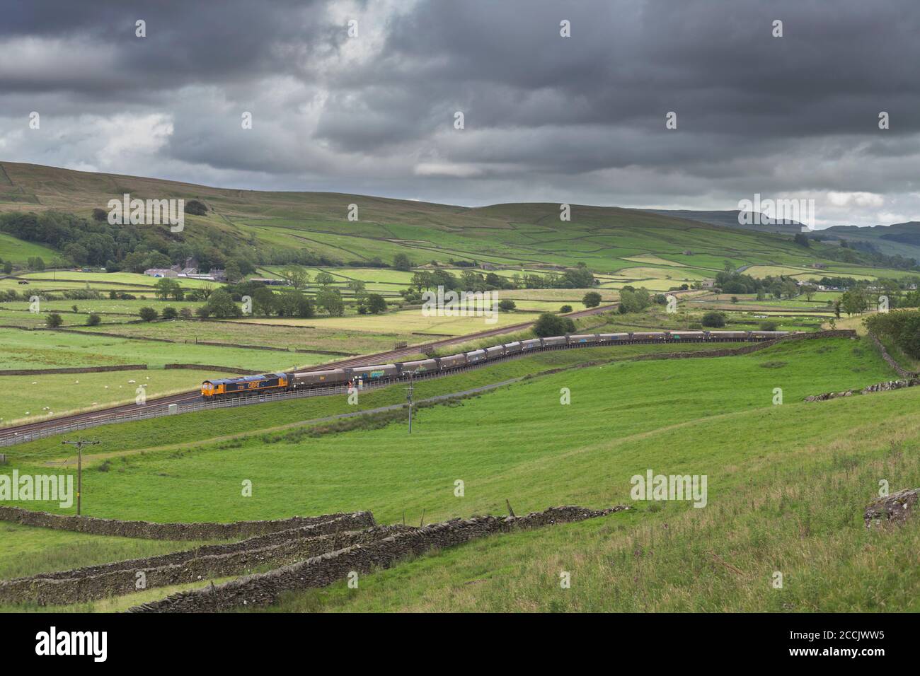 GB Railfreight class 66 locomotive leaving the siding at Arcow Quarry, Helwith Bridge on the Settle to Carlisle railway with a freight train Stock Photo