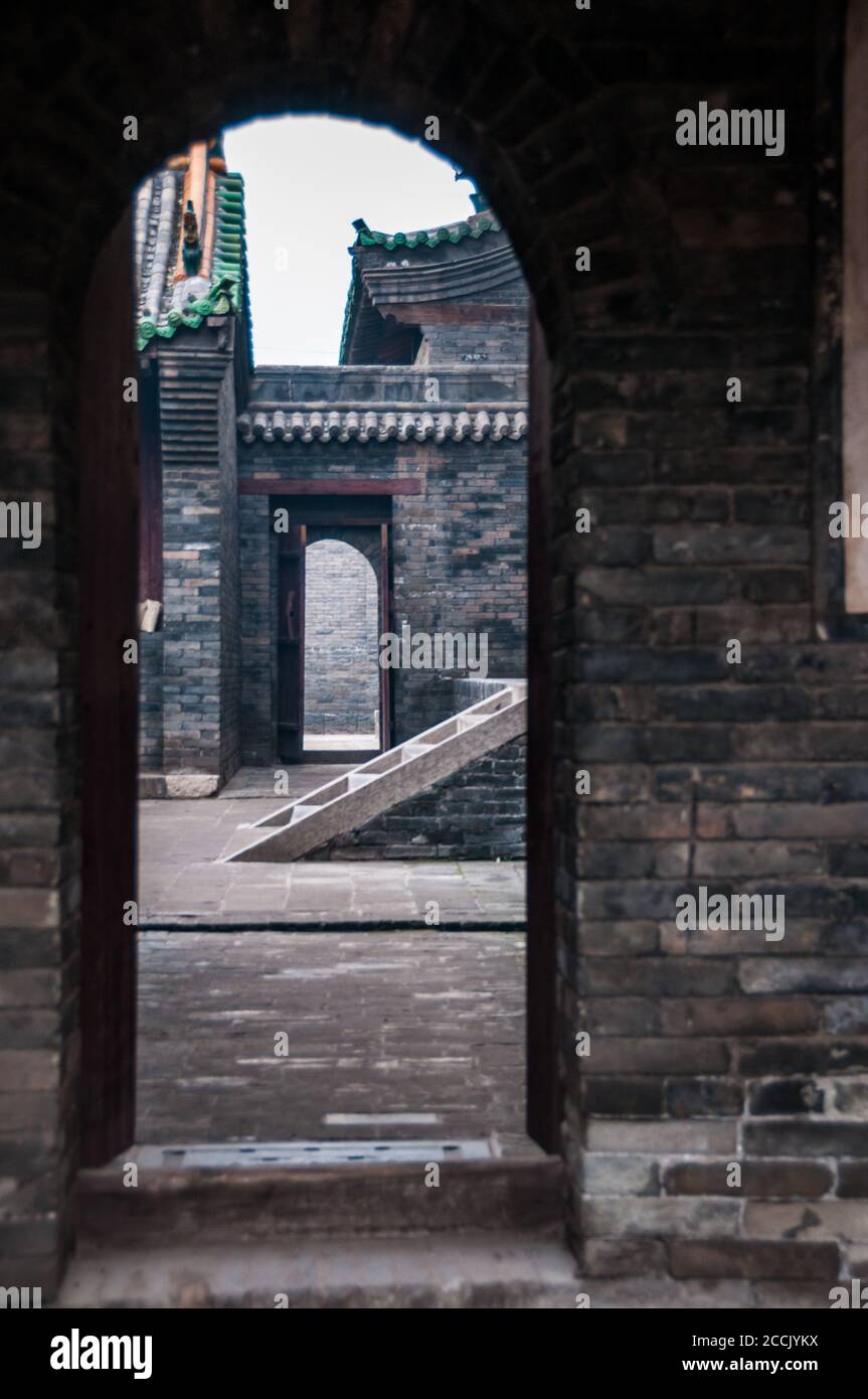 Old architecture showing an arched doorway at City God (Cheng Huang) temple in Pingyao, Shanxi Province, China. Stock Photo