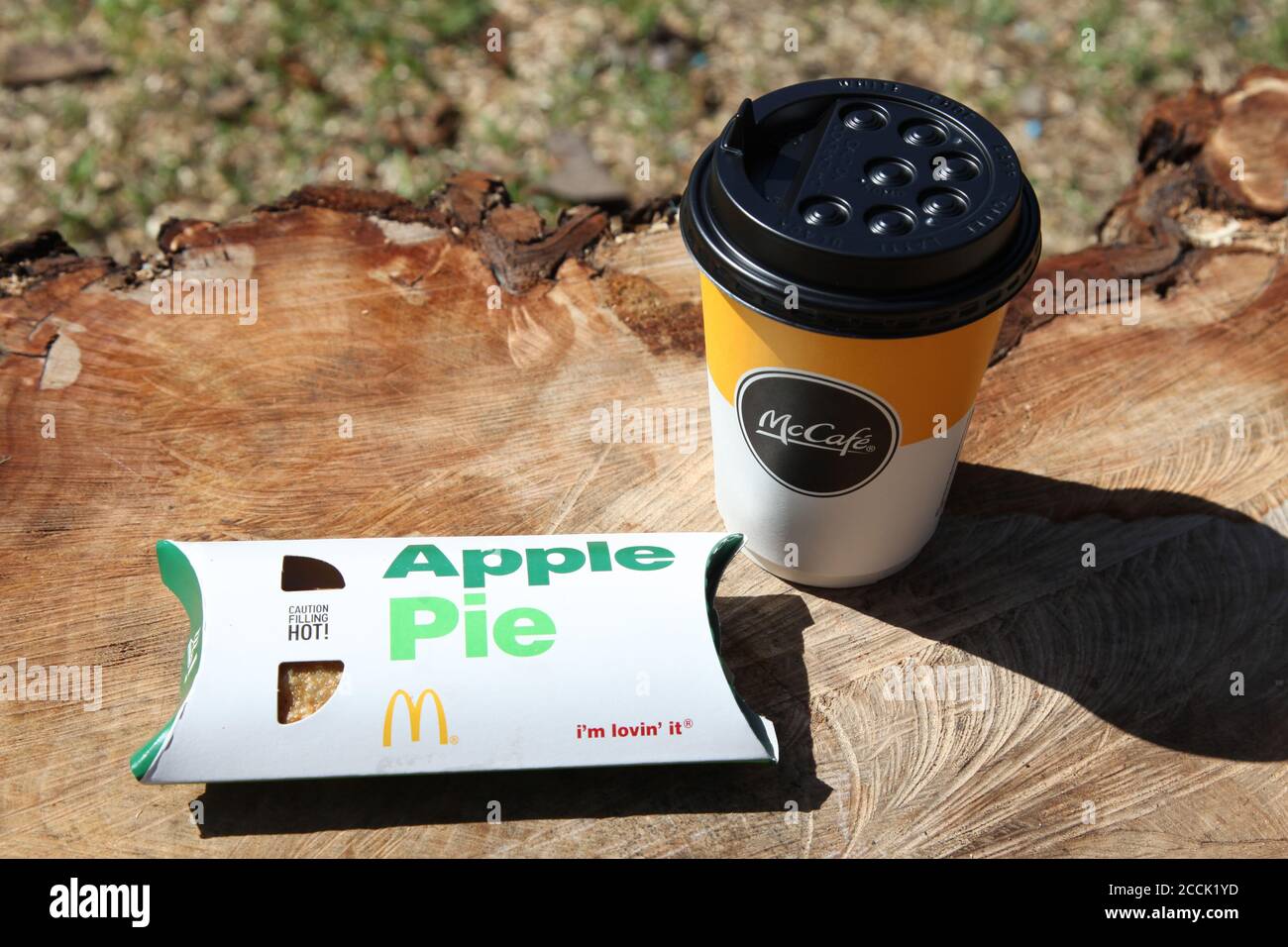 McDonald's Apple Pie and McCafe coffee cup outside, sunny day, 2020