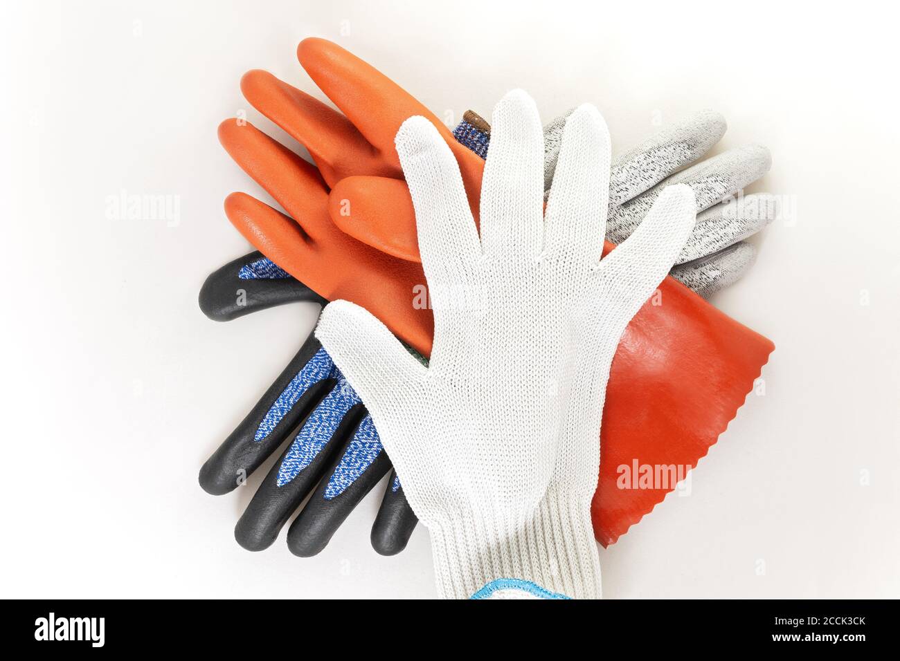 chemical resistant and cut resistant protective safety gloves in a stack against white Stock Photo